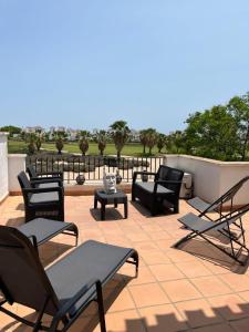 a patio with chairs and tables on a roof at Beautiful 2 Bed 2 Bath Townhouse - LA132LT in Torre-Pacheco