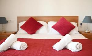 a bedroom with a large bed with towels on it at Apartment with pool & golf views - ER2113LT in Roldán +42 photos