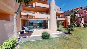 a view of a building with a couch in the yard at Spacious ground floor apartment - EO2402MM in Torre-Pacheco