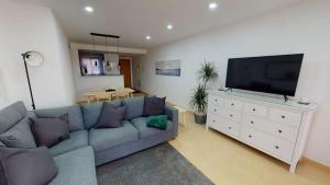 a living room with a couch and a flat screen tv at Spacious ground floor apartment - EO2402MM in Torre-Pacheco