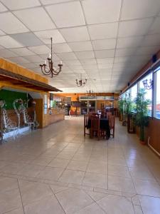 a dining area with a table and chairs in a building at Tierras Del Sol in Quilpué