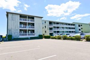 a parking lot in front of a building at Oceanfront and Modern Top Location on Ocean Blvd w Pool in Myrtle Beach