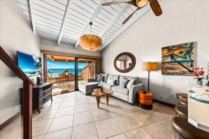 a living room with a couch and a table at Kuleana Resort 104 in Kahana