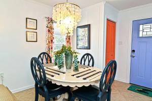 a dining room with a table with chairs and a chandelier at Mai Taid Beach House 1 Minute Walk to Beach in Myrtle Beach