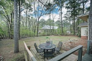 a patio with a table and chairs on a deck at 4 Bedroom 2 Bath Retreat in Jackson with Great Backyard in Jackson