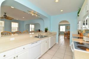 a large kitchen with white cabinets and a large mirror at Tropical Cherry Grove Ocean View Beach House w Pool in Myrtle Beach