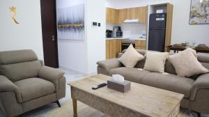 a living room with two couches and a coffee table at Vanilla Grove Calm 2BR Duplex Retreat in Oasis - Tranquil Stay Near Masdar Park & City Centre in Abu Dhabi