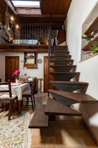 a staircase in a room with a table and chairs at Your luxury room Civitella in Civitella dʼAgliano