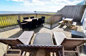 a deck with a table and chairs and a table and benches at Hazels Castle Huge 2 in 1 Oceanfront House near Pier in Myrtle Beach