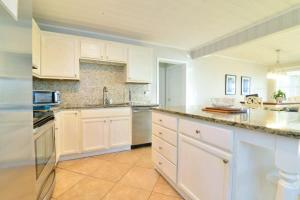 a large white kitchen with white cabinets and appliances at Hazels Castle Huge 2 in 1 Oceanfront House near Pier in Myrtle Beach