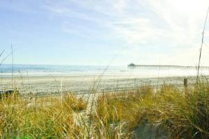 a view of a beach with a pier in the distance at Hazels Castle Huge 2 in 1 Oceanfront House near Pier in Myrtle Beach +43 photos