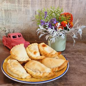 a plate of bread and a red truck and flowers at Posada El Prado in Salta +34 photos