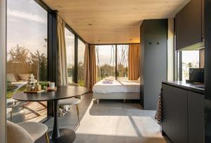 a bedroom with a bed and a table in a room at ÖÖD Sunrise at Buitenplaats Zeeuwse Liefde in Westkapelle