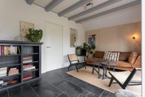 a living room with a couch and a table at De Kleine Schuur at Buitenplaats Zeeuwse Liefde in Westkapelle