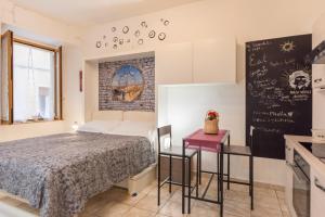 1 dormitorio con cama y pizarra en la pared en Panariello a Portamedina, en Nápoles