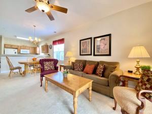 a living room with a couch and a table at Lakefront Condo w Huge Waterfront Pool Hot Tub in North Myrtle Beach