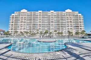 a large apartment building with a large swimming pool at Lakefront Condo w Huge Waterfront Pool Hot Tub in North Myrtle Beach