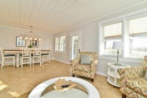 a living room with chairs and a table at HAZELS CHILD II Beach House DIRECT OCEANFRONT Ocean and Pier Views in Myrtle Beach