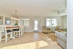 a dining room and living room with a table and chairs at HAZELS CHILD II Beach House DIRECT OCEANFRONT Ocean and Pier Views in Myrtle Beach +41 photos