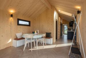 una habitación con mesa y sillas en una cabaña en Hello Zeeland - Zeeuwse Liefde Tiny House 8, en Westkapelle