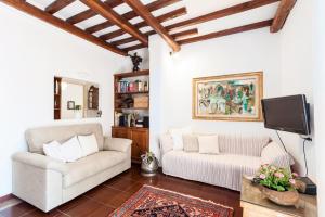 a living room with two white couches and a tv at Otranto in Rome