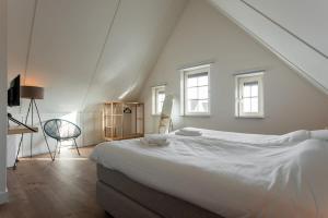 En eller flere senger på et rom på Hello Zeeland - vakantiewoning Knuitershoek 80