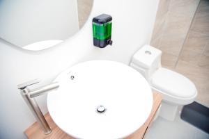 a bathroom with a white toilet and a sink at CASA HOTEL SANTA INES in Mompós