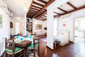 a dining room and living room with a table and chairs at Otranto in Rome