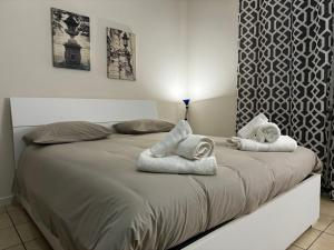 a bedroom with a bed with towels on it at Appartamento Blue View in Peschiera del Garda