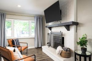 a living room with a fireplace with a tv above it at Denver Family Retreat 4BR 3 BA - Large Backyard in Arvada