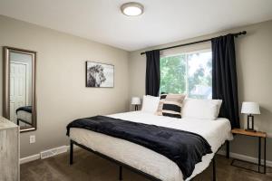a bedroom with a large bed and a window at Denver Family Retreat 4BR 3 BA - Large Backyard in Arvada
