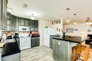 a kitchen with green cabinets and white appliances at Sweet Caroline by the Coast - Short Walk to the Beach or Jetty Park in Surfside Beach