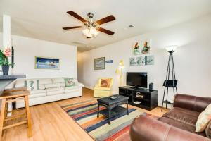 a living room with a couch and a tv at Sweet Caroline by the Coast - Short Walk to the Beach or Jetty Park in Surfside Beach +27 photos