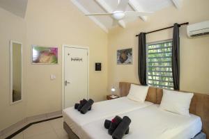 a bedroom with two beds and a window at Caracara D1 Relax & Dive Resort Bonaire Village in Kralendijk