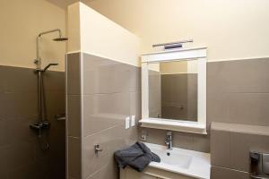 a bathroom with a sink and a mirror at Caracara D1 Relax & Dive Resort Bonaire Village in Kralendijk