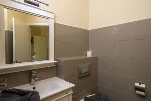 a bathroom with a sink and a mirror at Caracara D1 Relax & Dive Resort Bonaire Village in Kralendijk
