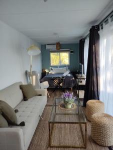 - un salon avec un canapé et une table dans l'établissement Tiny house OMA, à Laguna Verde