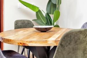 a wooden table with a bowl on top of it at Chachacha Apartment At Sea with Ocean View in Kralendijk