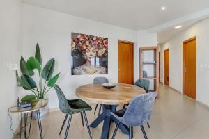 a dining room with a wooden table and chairs at Chachacha Apartment At Sea with Ocean View in Kralendijk