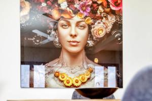 a painting of a woman with a necklace on her head at Chachacha Apartment At Sea with Ocean View in Kralendijk +26 photos