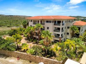 an aerial view of a building with palm trees at Bon Bini Bon Bida with Lovely Communal Pool in Kralendijk