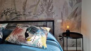 a bedroom with a bed with pillows and a wall at Arbanella in Corniglia