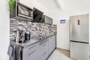 a kitchen with a stainless steel refrigerator and a counter top at Caribbean Court Studio 321 in Kralendijk