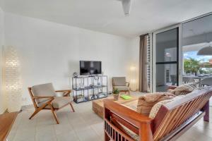 a living room with a couch and a table at Casa Leeward with Pool on the Laguna Marina in Kralendijk