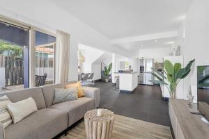 a living room with a couch and a kitchen at Kas Linde with private pool on the Laguna Marina in Kralendijk