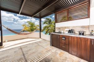 eine Küche mit Hängematte vor dem Meer in der Unterkunft Nirvana Lodge with Private Pool and House Reef in Kralendijk