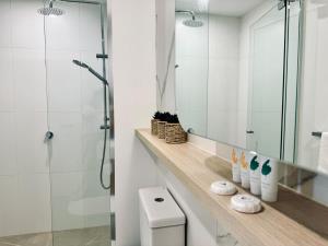 a bathroom with a shower and a toilet and a mirror at Chic 1BR Apt Urban Retreat Pool Parking Gym in Box Hill +39 photos