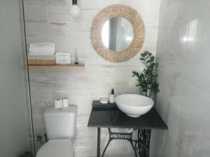 a bathroom with a sink and a toilet and a mirror at Retiro dos sonhos in Porches