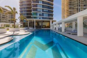 a swimming pool in a building with tall buildings at Just a stone's throw to the Beach Brand new 2BR in Gold Coast