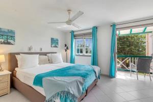 a bedroom with a bed and a large window at Port Bonaire Seascape A301 with Sea Views and Pool in Kralendijk +35 photos